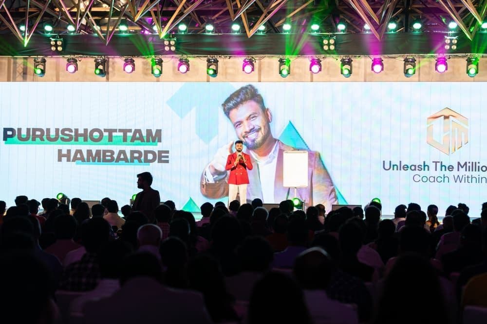 Purushottam on stage at a live event