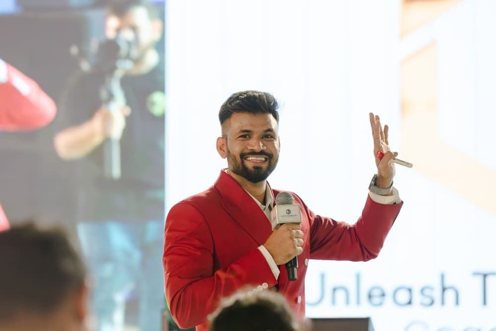 Purushottam mid-gesture on stage